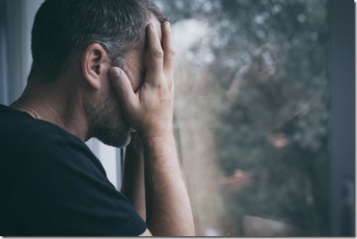 portrait one sad man standing near a window