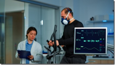 Team of medial researcher monitoring vo2 of man