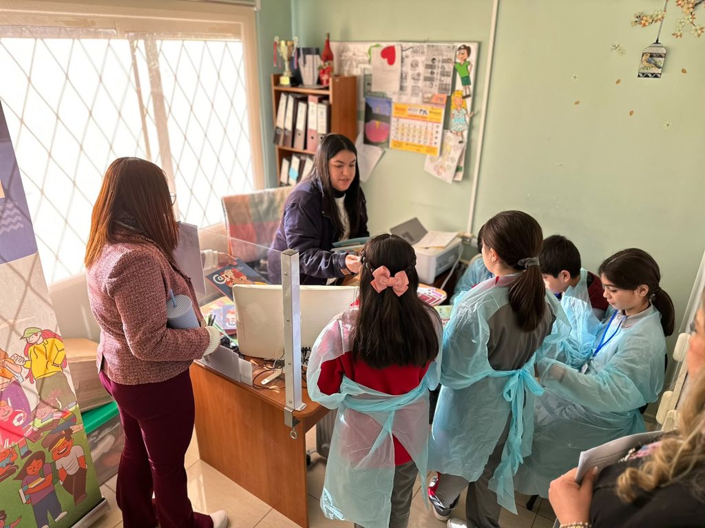 Estudiantes de escuela básica participando en actividades educativas sobre salud y servicios de emergencia en Frutillar